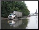 Truck negotiates flood water on Flat Rock Road