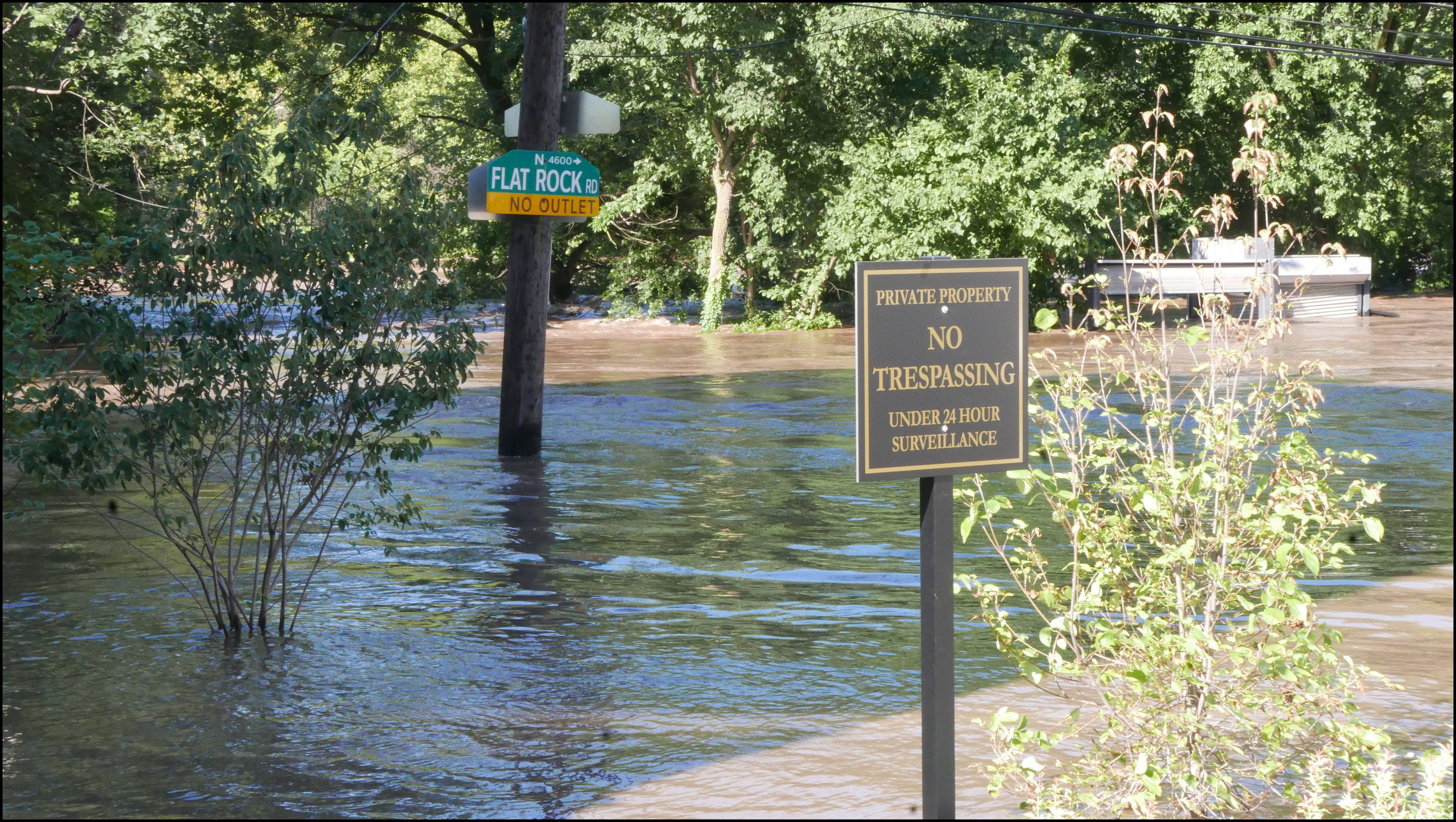 Leverington and Flat Rock Road -- There is a parking lot behind the building top sticking up. Hope they got all the cars out.