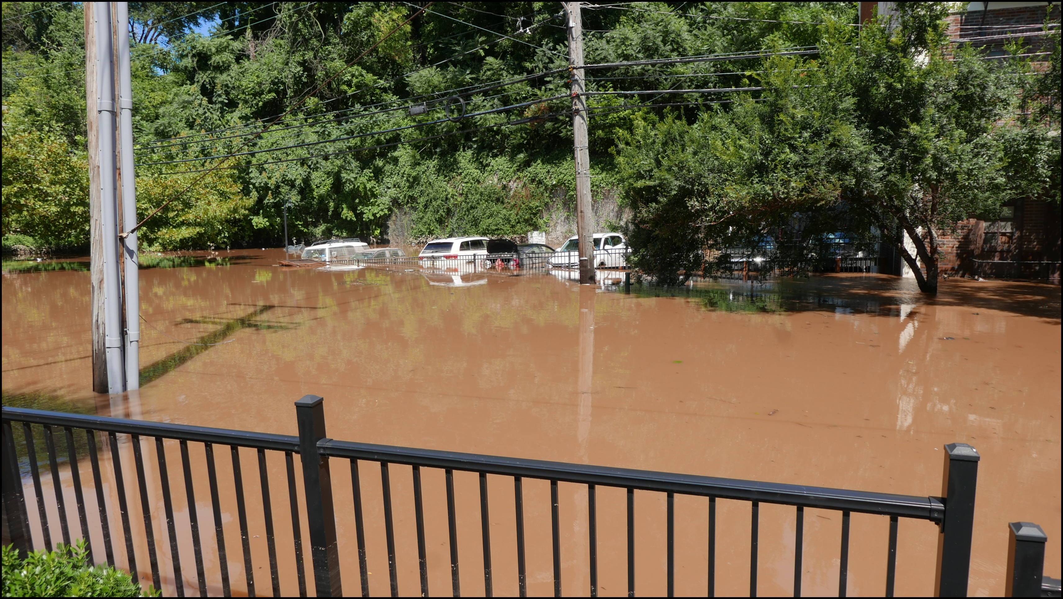 Southern limit of flooding on Main Street -- Flooded cars in the Yarn Factory Lofts (Wilde Yarn) parking lot.