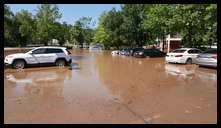 Southern limit of flooding on Main Street -- Flooded cars in the theater parking lot.