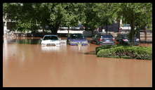 Southern limit of flooding on Main Street -- Flooded cars in the theater parking lot.