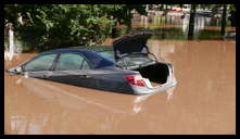 Southern limit of flooding on Main Street -- Flooded cars in the theater parking lot